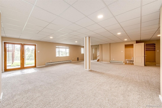 38879 Rusty Spur Trl, Agate, CO 80101 - basement with a baseboard heating unit, baseboard heating, carpet flooring, a paneled ceiling, and stairs