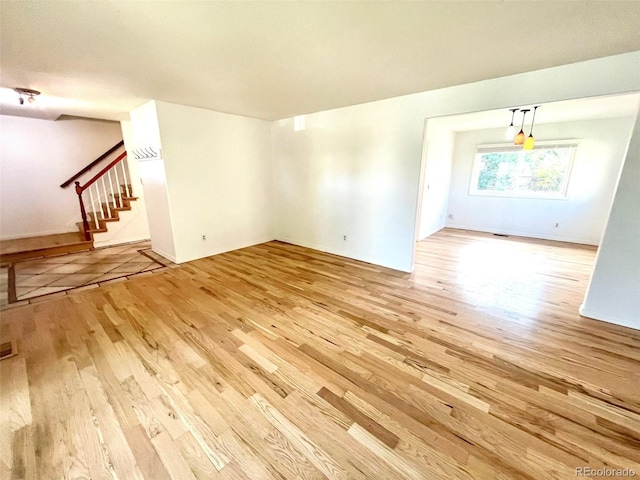 4753 S Gar Way, Littleton, CO 80123 - unfurnished living room featuring wood finished floors and stairs