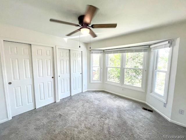 4753 S Gar Way, Littleton, CO 80123 - unfurnished bedroom featuring two closets, carpet, and ceiling fan