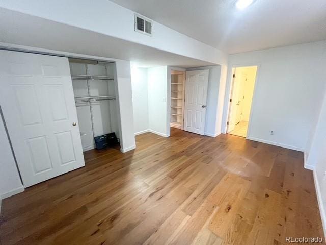 4753 S Gar Way, Littleton, CO 80123 - unfurnished bedroom with wood finished floors and a closet
