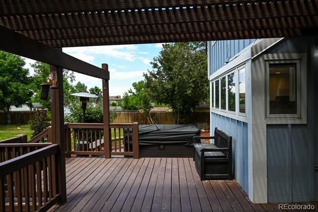 4753 S Gar Way, Littleton, CO 80123 - wooden terrace with a fenced backyard, a covered hot tub, and a pergola