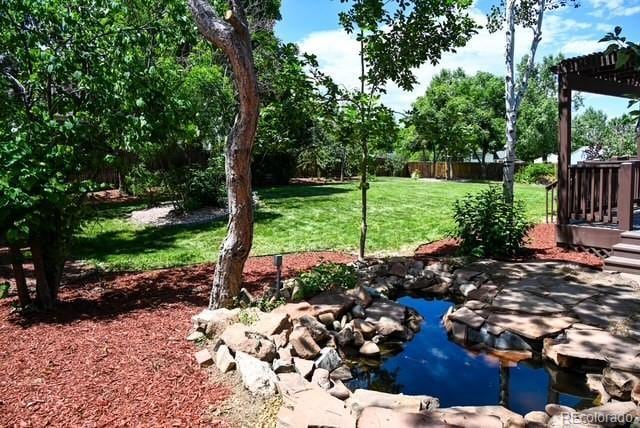 4753 S Gar Way, Littleton, CO 80123 - view of green lawn featuring a small pond