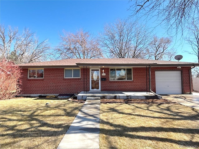 ranch-style house with a garage, driveway, a front yard, and brick siding