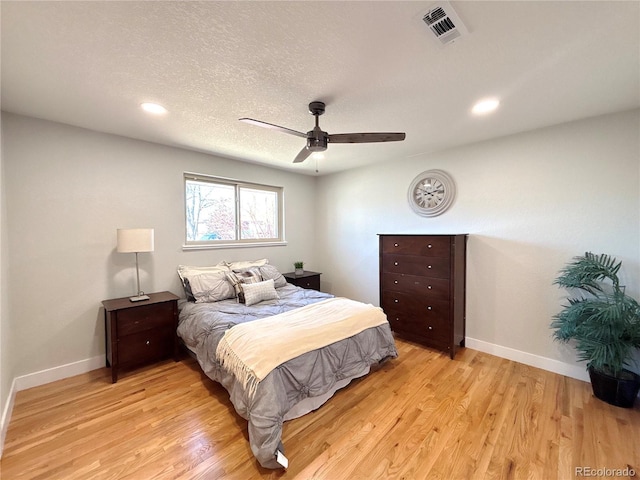 bedroom featuring light wood-type flooring, visible vents, and baseboards