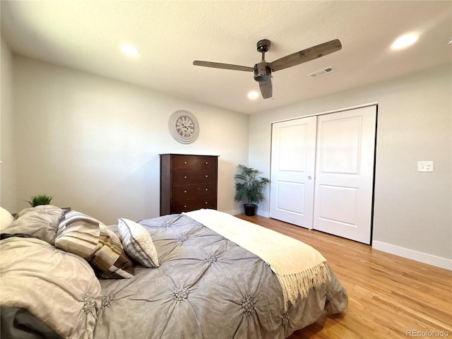 bedroom with baseboards, ceiling fan, light wood-type flooring, a closet, and recessed lighting