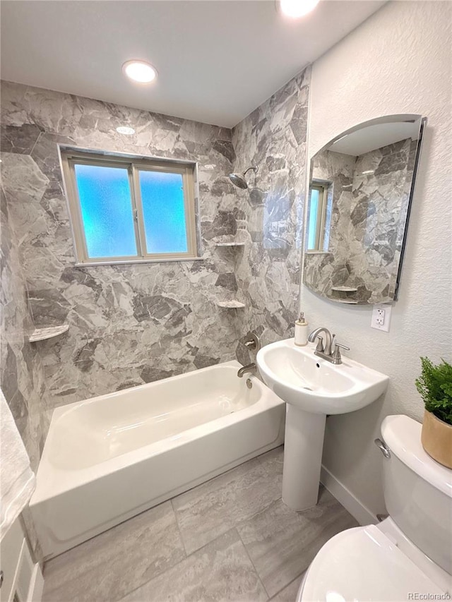 bathroom with toilet and bathing tub / shower combination