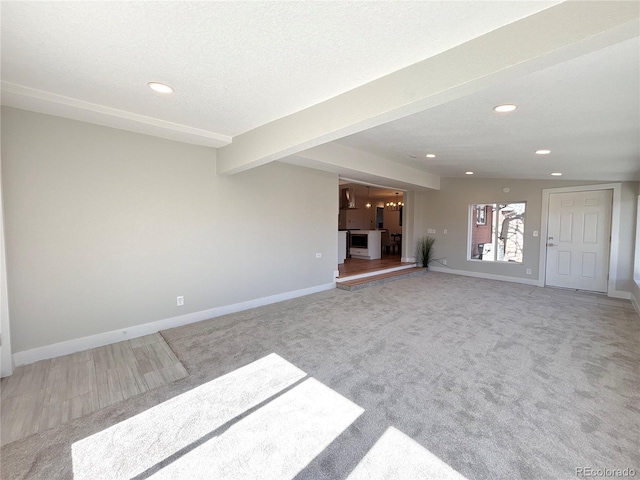 unfurnished living room featuring baseboards, carpet, a textured ceiling, beam ceiling, and recessed lighting