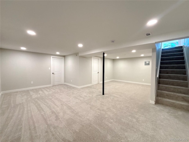 finished basement with recessed lighting, light colored carpet, baseboards, and stairs