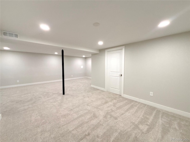 finished below grade area with recessed lighting, baseboards, visible vents, and light colored carpet