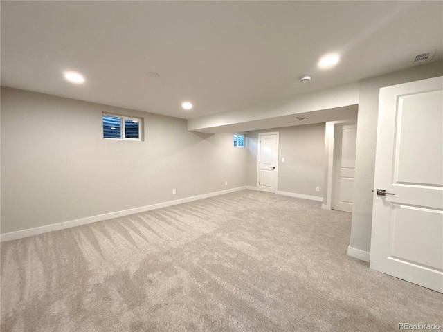 finished basement featuring light carpet, visible vents, baseboards, and recessed lighting