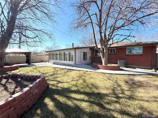 back of property with a patio, fence, a gazebo, central AC, and brick siding