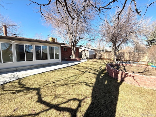 view of yard with a storage shed, fence, and an outbuilding