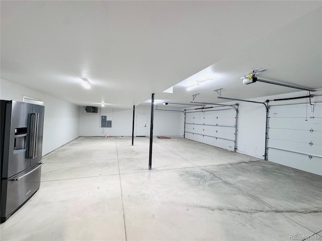 1282 N Crystal Rd, Lake George, CO 80827 - garage featuring stainless steel fridge with ice dispenser, a garage door opener, and electric panel