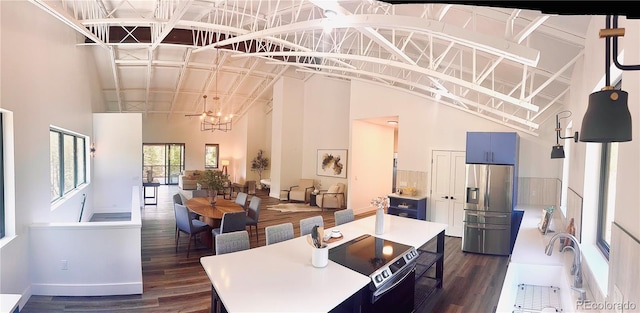 1282 N Crystal Rd, Lake George, CO 80827 - dining space featuring dark wood-style flooring, high vaulted ceiling, baseboards, and a chandelier