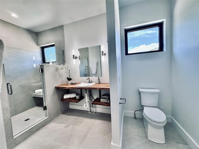 1282 N Crystal Rd, Lake George, CO 80827 - bathroom featuring a shower stall, toilet, vanity, and baseboards