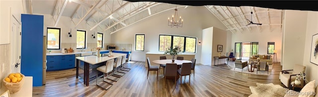 1282 N Crystal Rd, Lake George, CO 80827 - dining space featuring high vaulted ceiling, wood finished floors, beam ceiling, a chandelier, and baseboards
