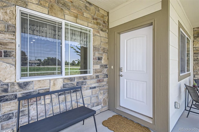 1746 Westward Cir Unit 1, Eaton, CO 80615 - view of exterior entry featuring stone siding and a porch
