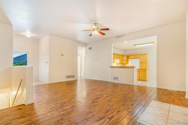 6796 S Newcombe Way, Littleton, CO 80127 - unfurnished living room with light wood-type flooring and a ceiling fan