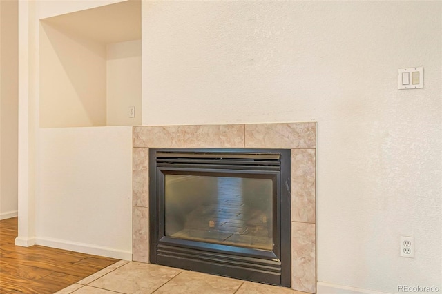 6796 S Newcombe Way, Littleton, CO 80127 - detailed view of a tiled fireplace and wood finished floors