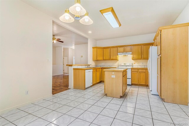6796 S Newcombe Way, Littleton, CO 80127 - kitchen with white appliances, under cabinet range hood, a peninsula, a kitchen island, and open floor plan