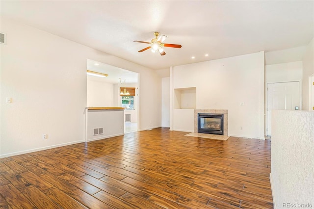6796 S Newcombe Way, Littleton, CO 80127 - unfurnished living room with ceiling fan, wood finished floors, a tiled fireplace, and recessed lighting