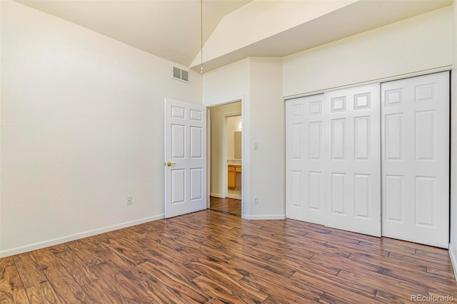 6796 S Newcombe Way, Littleton, CO 80127 - unfurnished bedroom featuring dark wood-type flooring, high vaulted ceiling, and a closet