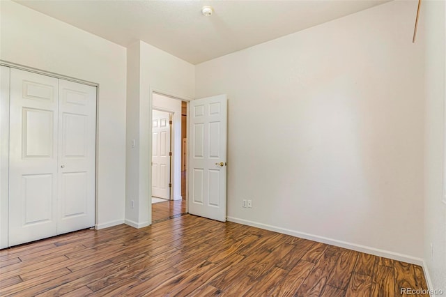6796 S Newcombe Way, Littleton, CO 80127 - unfurnished bedroom with wood finished floors and a closet