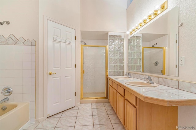 6796 S Newcombe Way, Littleton, CO 80127 - full bathroom featuring tile patterned floors, a stall shower, double vanity, and a garden tub