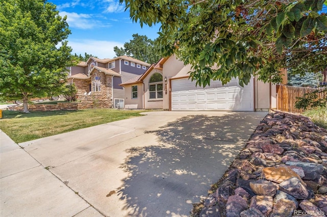 6796 S Newcombe Way, Littleton, CO 80127 - view of front of home featuring concrete driveway, an attached garage, stucco siding, and stone siding