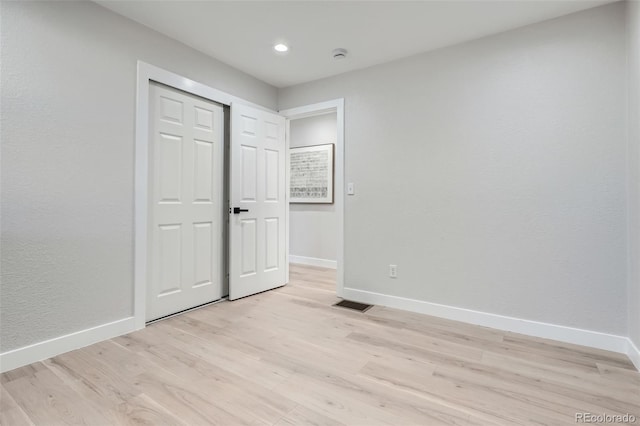 unfurnished bedroom with baseboards, light wood-style floors, and recessed lighting