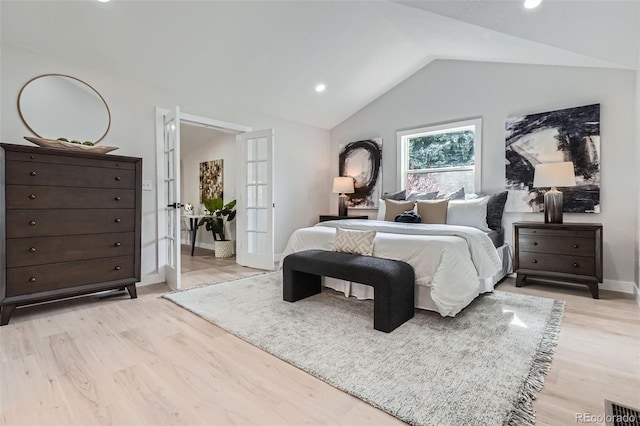 bedroom with light wood-type flooring, vaulted ceiling, french doors, and visible vents