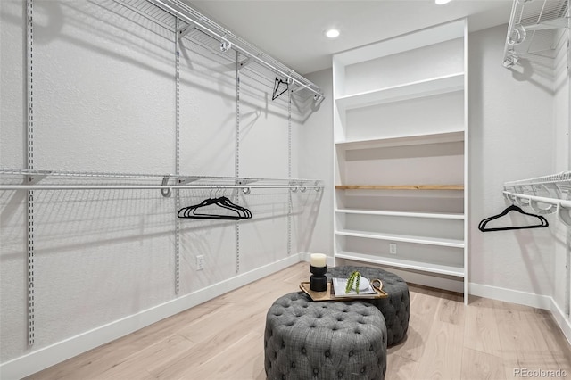 walk in closet featuring wood finished floors