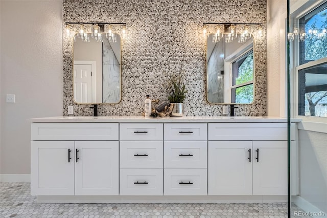 bathroom featuring a sink, tile patterned flooring, double vanity, and tasteful backsplash