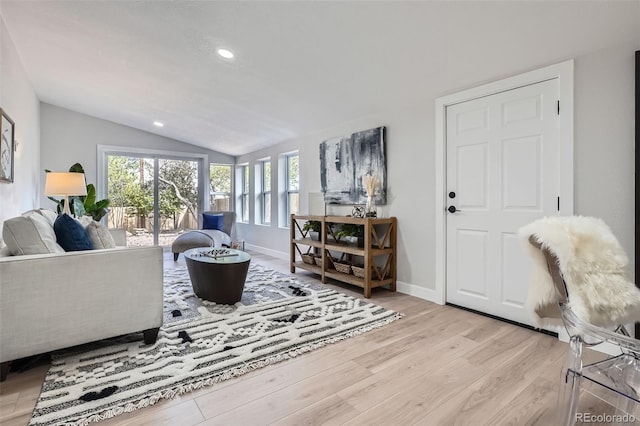 living area with lofted ceiling, light wood-style flooring, baseboards, and recessed lighting
