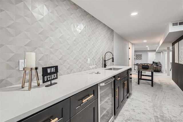bar featuring light carpet, wine cooler, a sink, visible vents, and recessed lighting