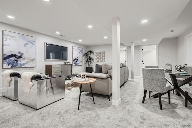 living area with baseboards, light carpet, and recessed lighting