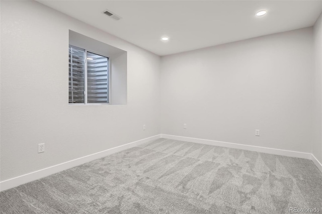 carpeted spare room with recessed lighting, visible vents, and baseboards