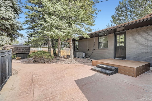 view of patio featuring fence and central AC