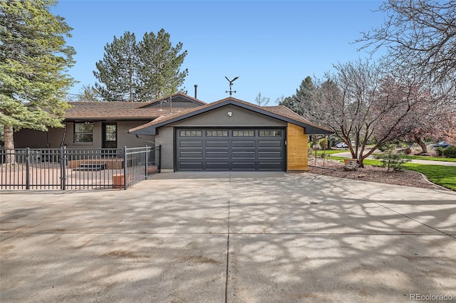 single story home with fence, an attached garage, and concrete driveway