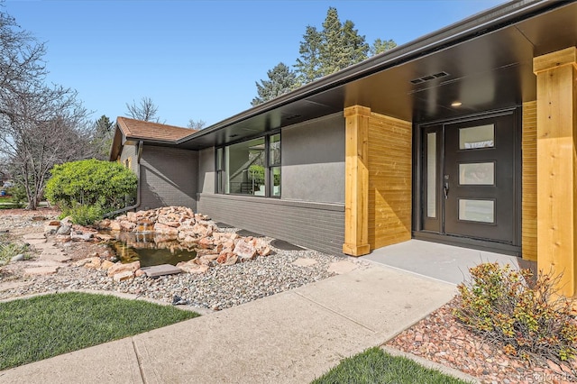 entrance to property featuring brick siding