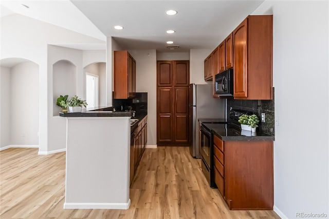 kitchen with baseboards, black appliances, light wood-style flooring, and tasteful backsplash