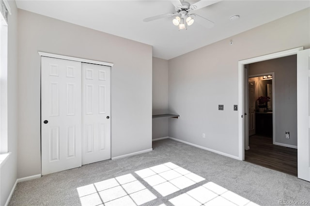 unfurnished bedroom featuring carpet floors, baseboards, a closet, and a ceiling fan