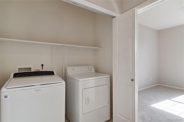 laundry area with washer and dryer, laundry area, light carpet, and baseboards