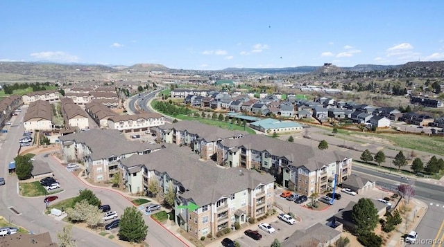 aerial overview of property's location featuring a mountain backdrop and nearby suburban area