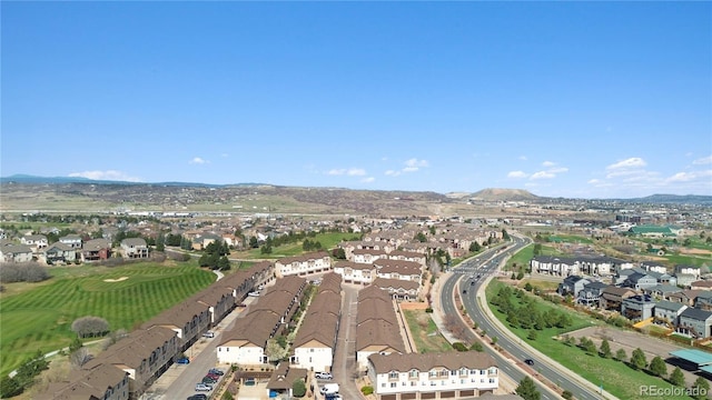 aerial view of property's location featuring nearby suburban area and a mountainous background