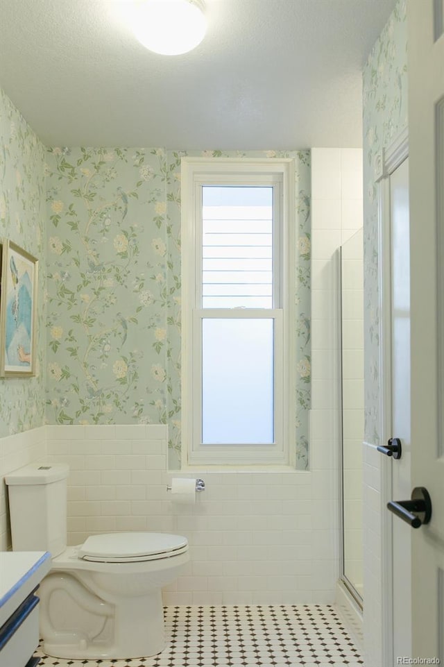 3410 W 31st Ave, Denver, CO 80211 - bathroom featuring wallpapered walls, a wainscoted wall, vanity, tile patterned floors, and tile walls