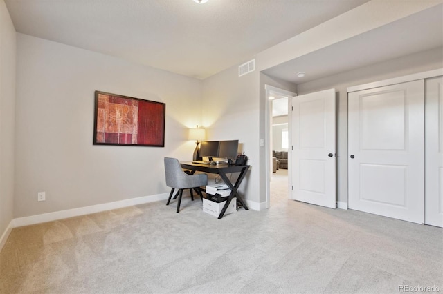 carpeted office featuring baseboards and visible vents