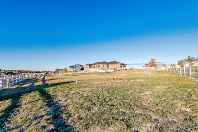 view of yard featuring a rural view and fence