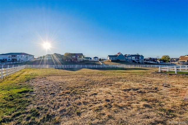 view of yard featuring fence and a residential view
