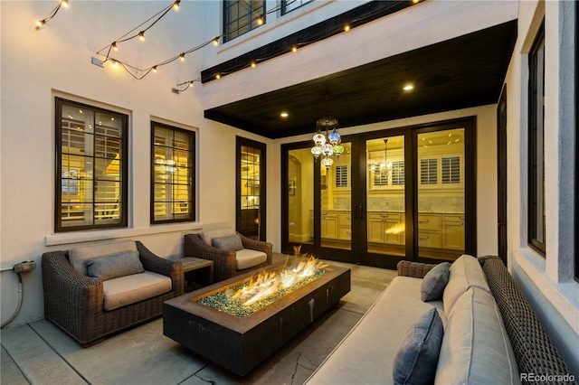 view of patio with an outdoor living space with a fire pit